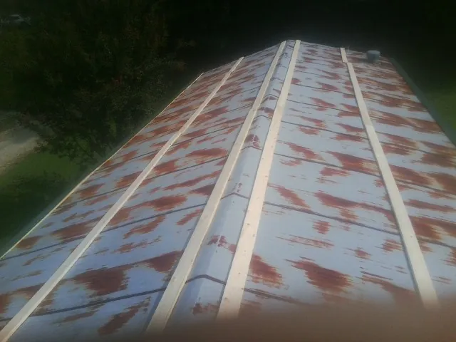 Rusted metal roof panels with new wood purlins before replacement — Storm Damage Roof Repair in Union by Roofing Brothers