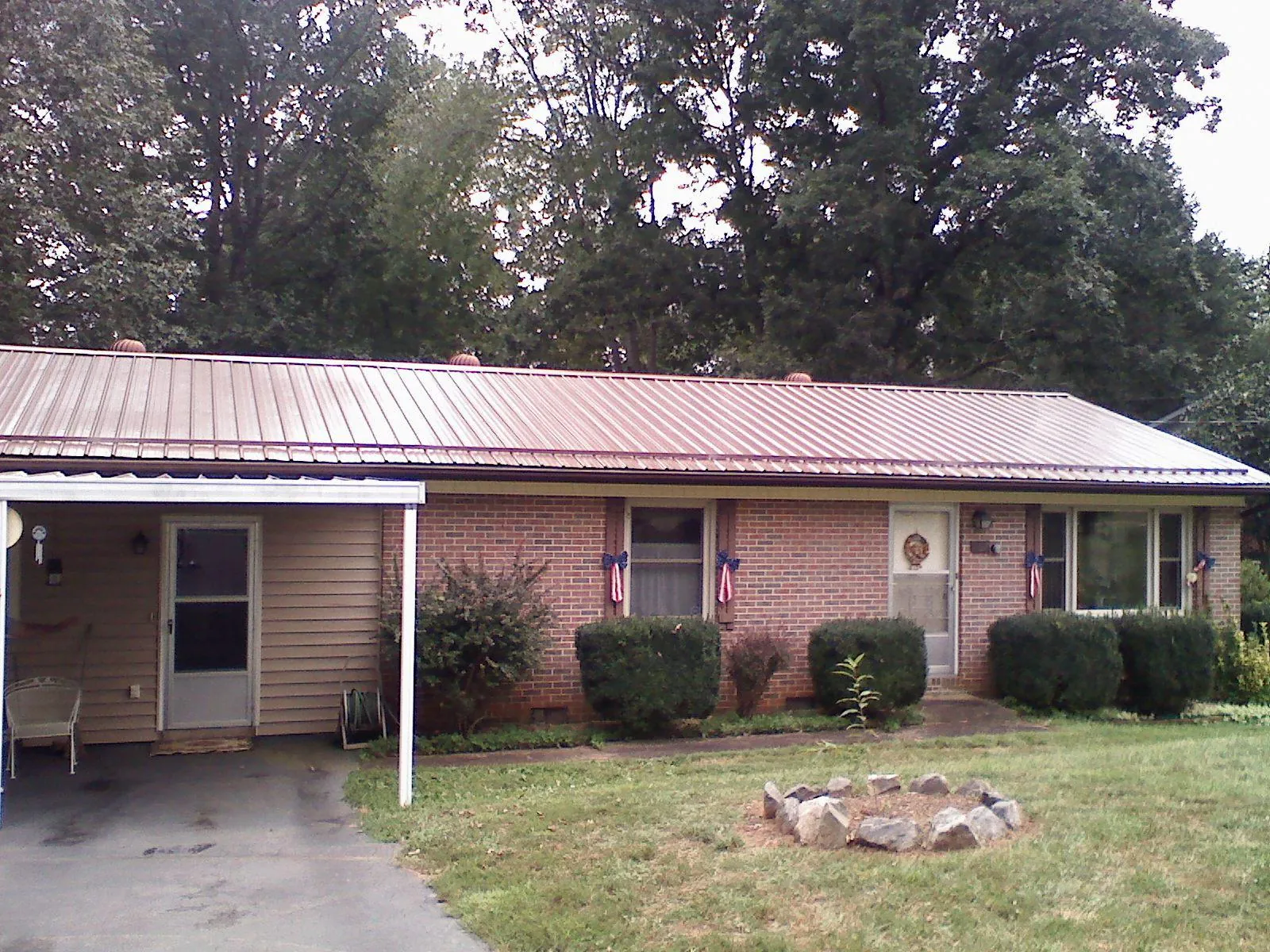 Bronze metal roof and carport on a brick ranch home — Roof Repair work by our crew in Union